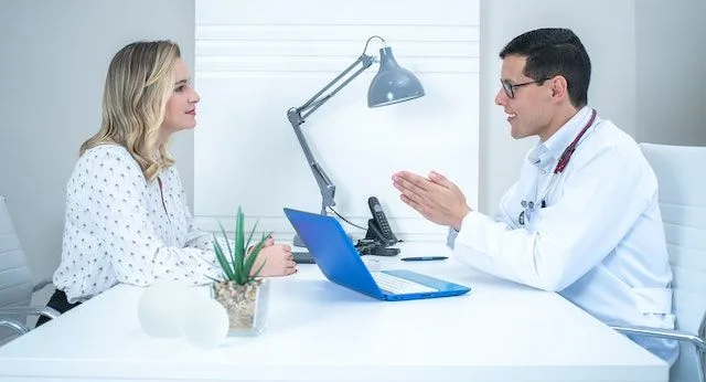 Doctor explaining to a patient how important it is to know how to talk to your doctor.