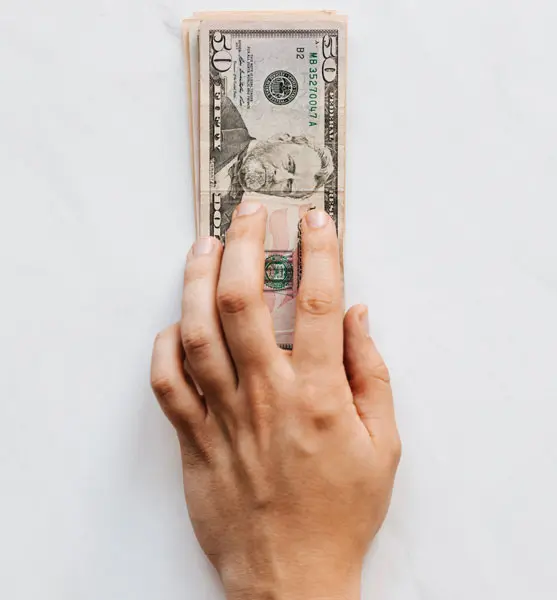 US dollars and a human hand