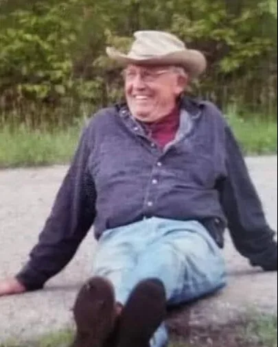 older man sitting down and smiling