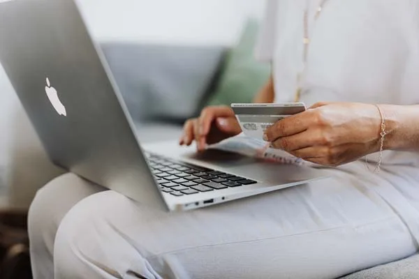 person shopping with laptop and credit card