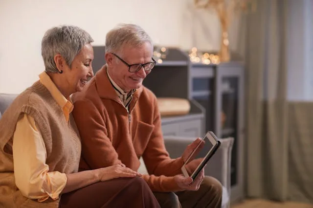 elderly couple looking at brochure