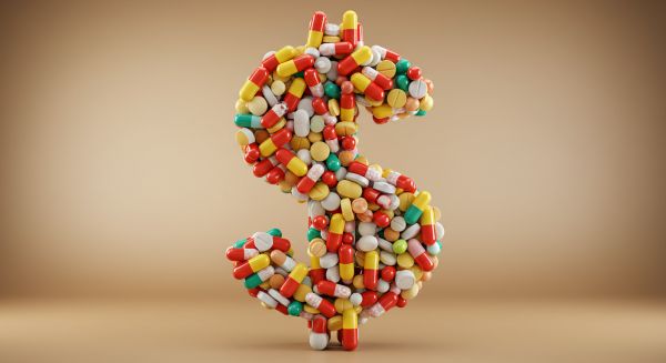 Image of multi-colored pills that form a dollar sign.