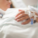 Hospital Indemnity: The Smart Fix for High Deductibles woman in hosp;ital with monitors on her hand